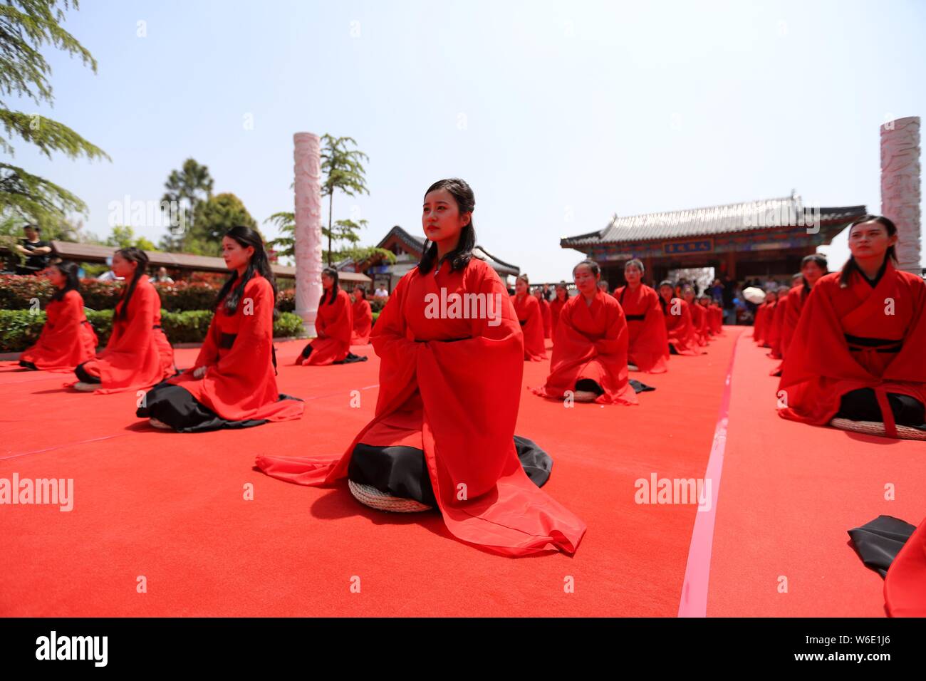 Chinese girls dressed in traditional Han costumes take part in a ...