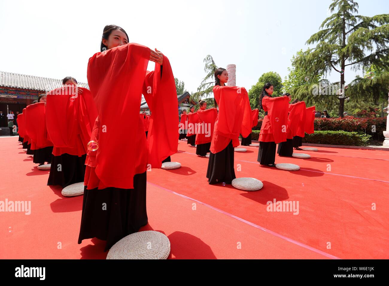 Chinese girls dressed in traditional Han costumes take part in a ...