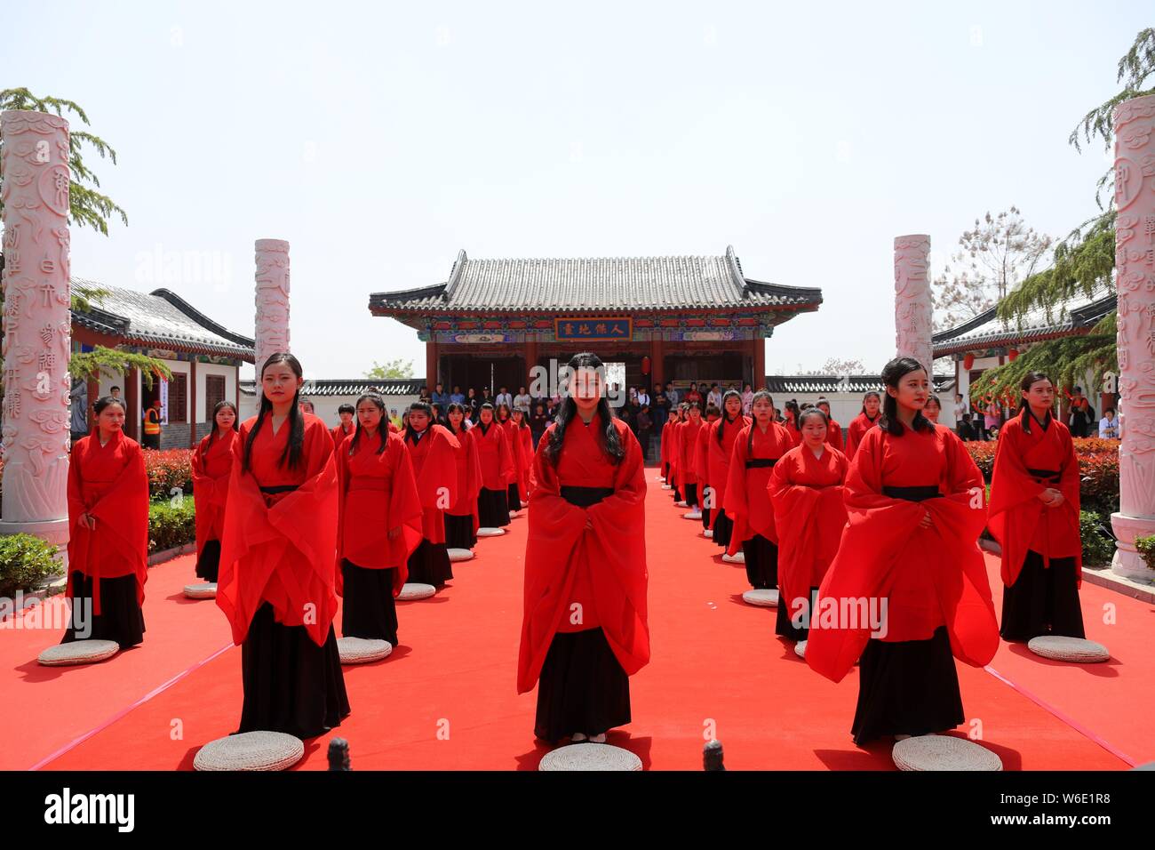 Chinese girls dressed in traditional Han costumes take part in a ...