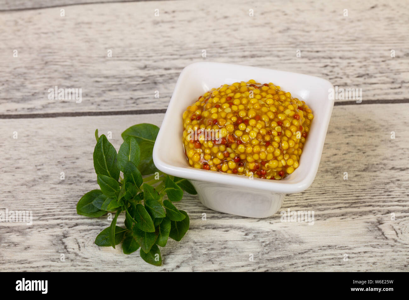 Traditionnal dijon mustard served basil leaves Stock Photo Alamy