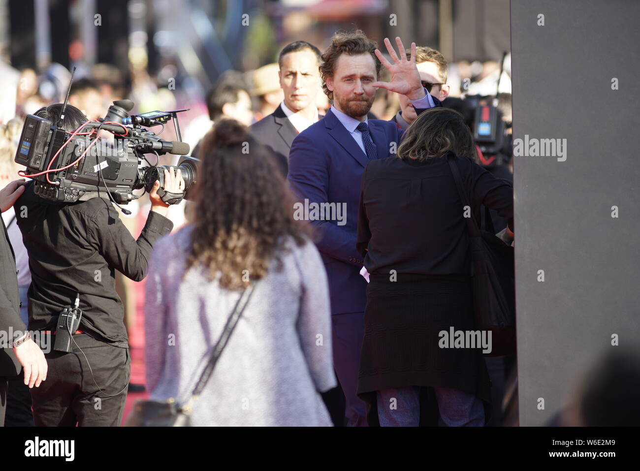 English actor Tom Hiddleston waves as he arrives on the red carpet of a