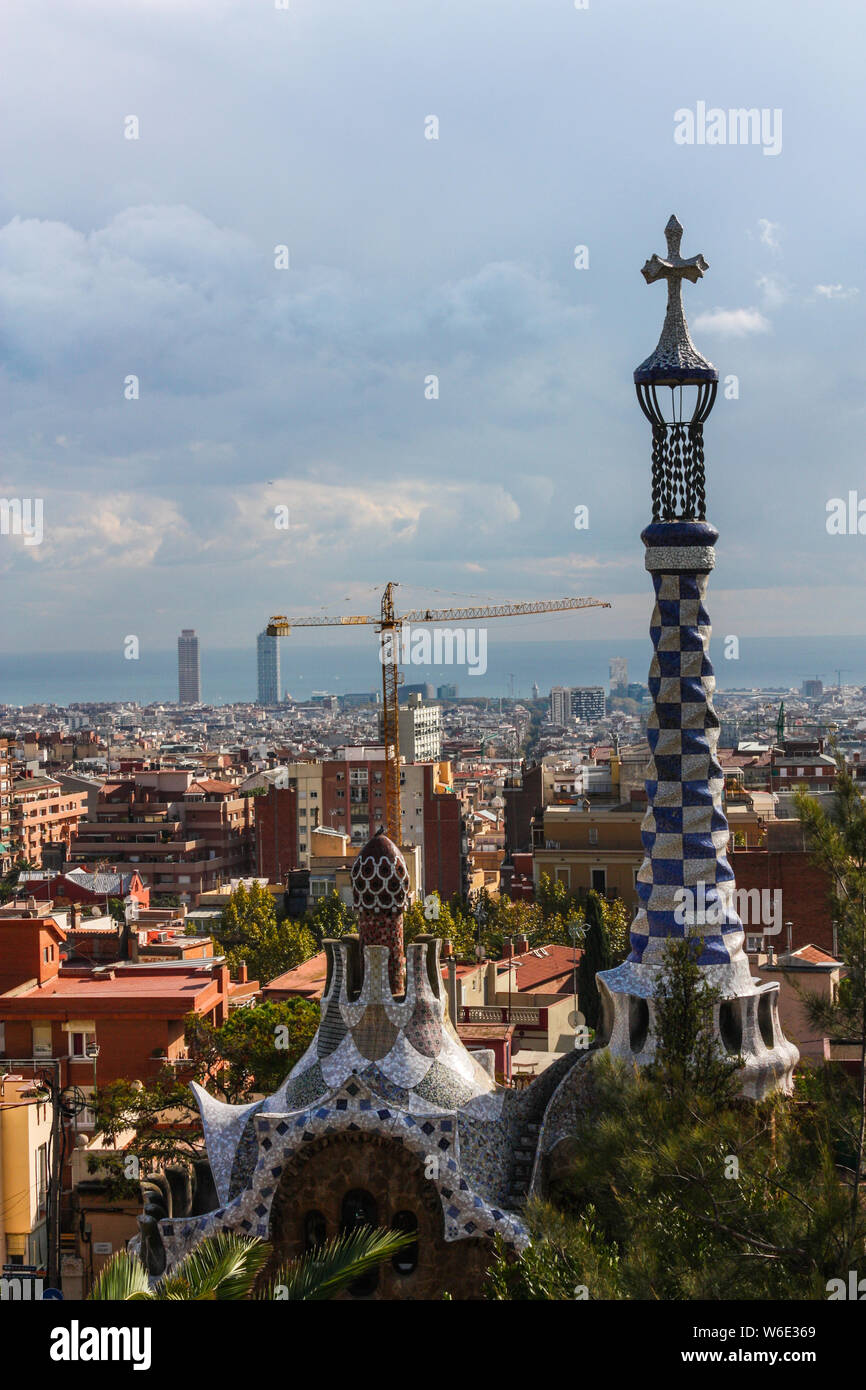 Overview of the Right Pavilion with a Pinnacle, crowned with a Gaudi-typical five-beam cross of the Park Guell in Barcelona, Catalonia, Spain Stock Photo