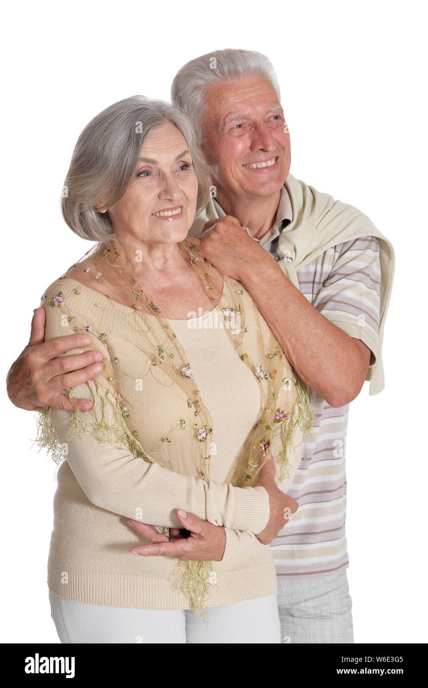 Portrait of happy senior couple hugging on white background Stock Photo