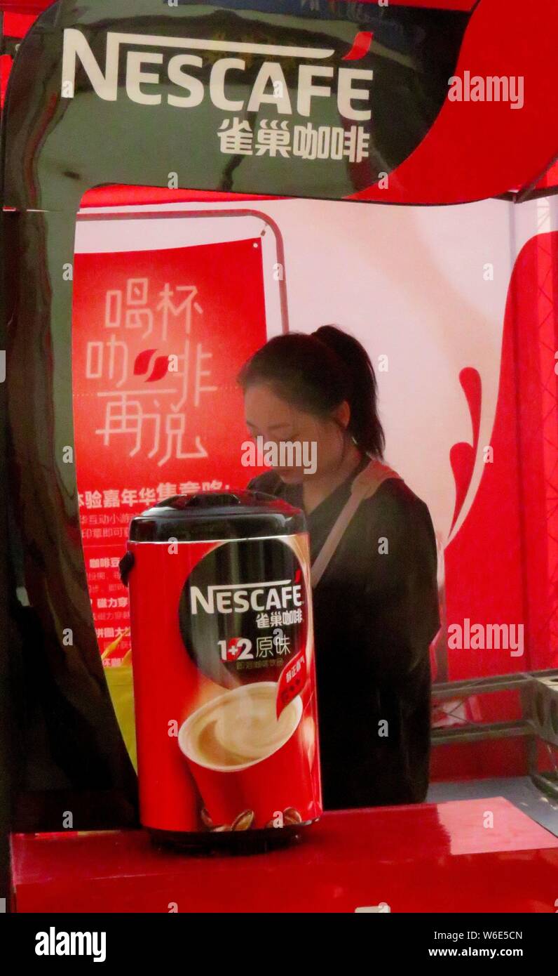 --FILE--A salesperson is pictured in the stand of Nescafe instant coffee of Nestle in Yichang city, central China's Hubei province, 4 November 2017. Stock Photo