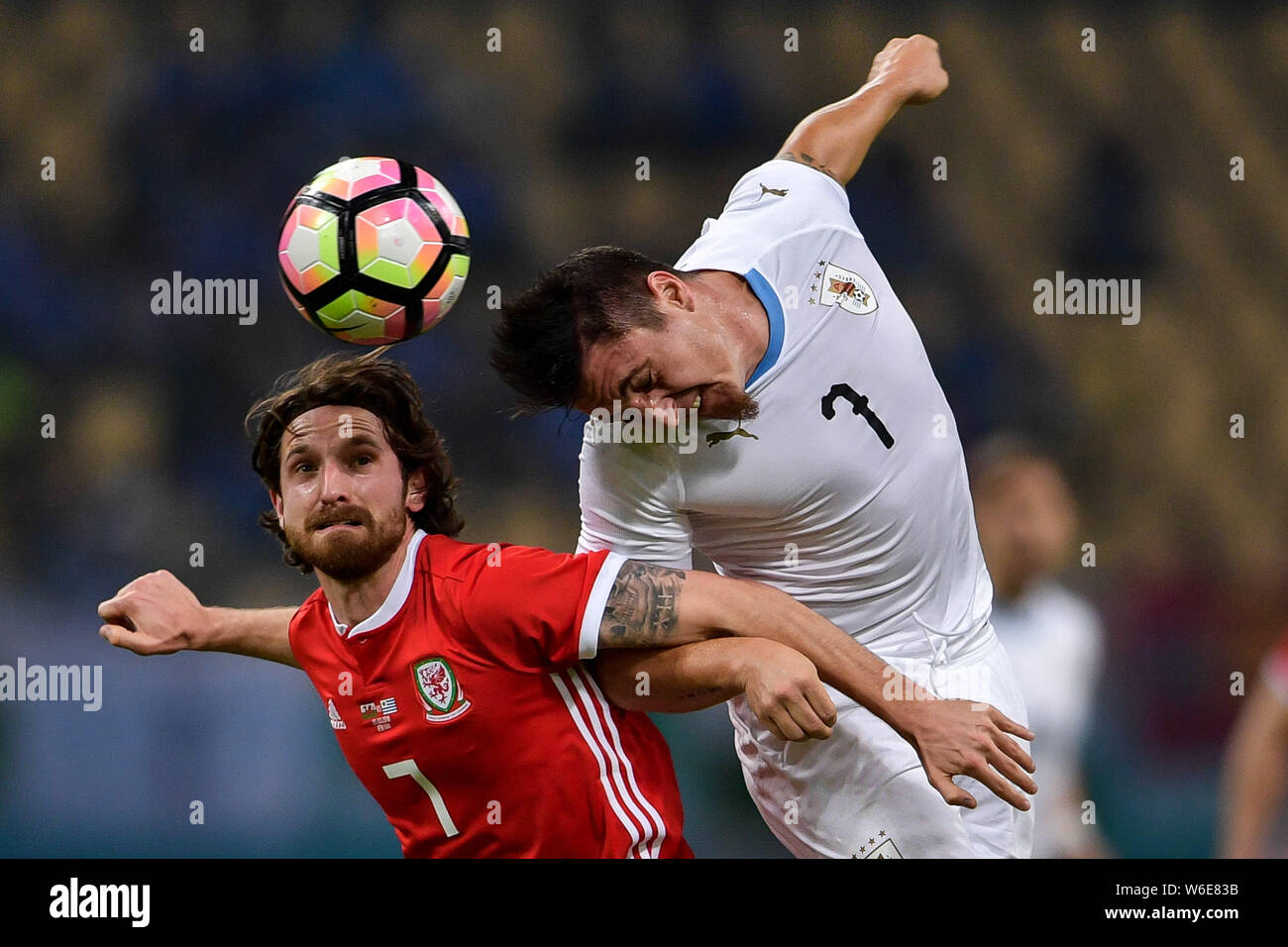 Joe Allen, left, of Wales national football team heads the ball to make a pass against Cristian Rodriguez of Uruguay national football team in their f Stock Photo