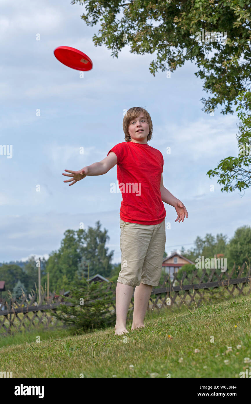 boy throwing frisbee disc, Freiberg, Bayerischer Wald, Bavaria, Germany