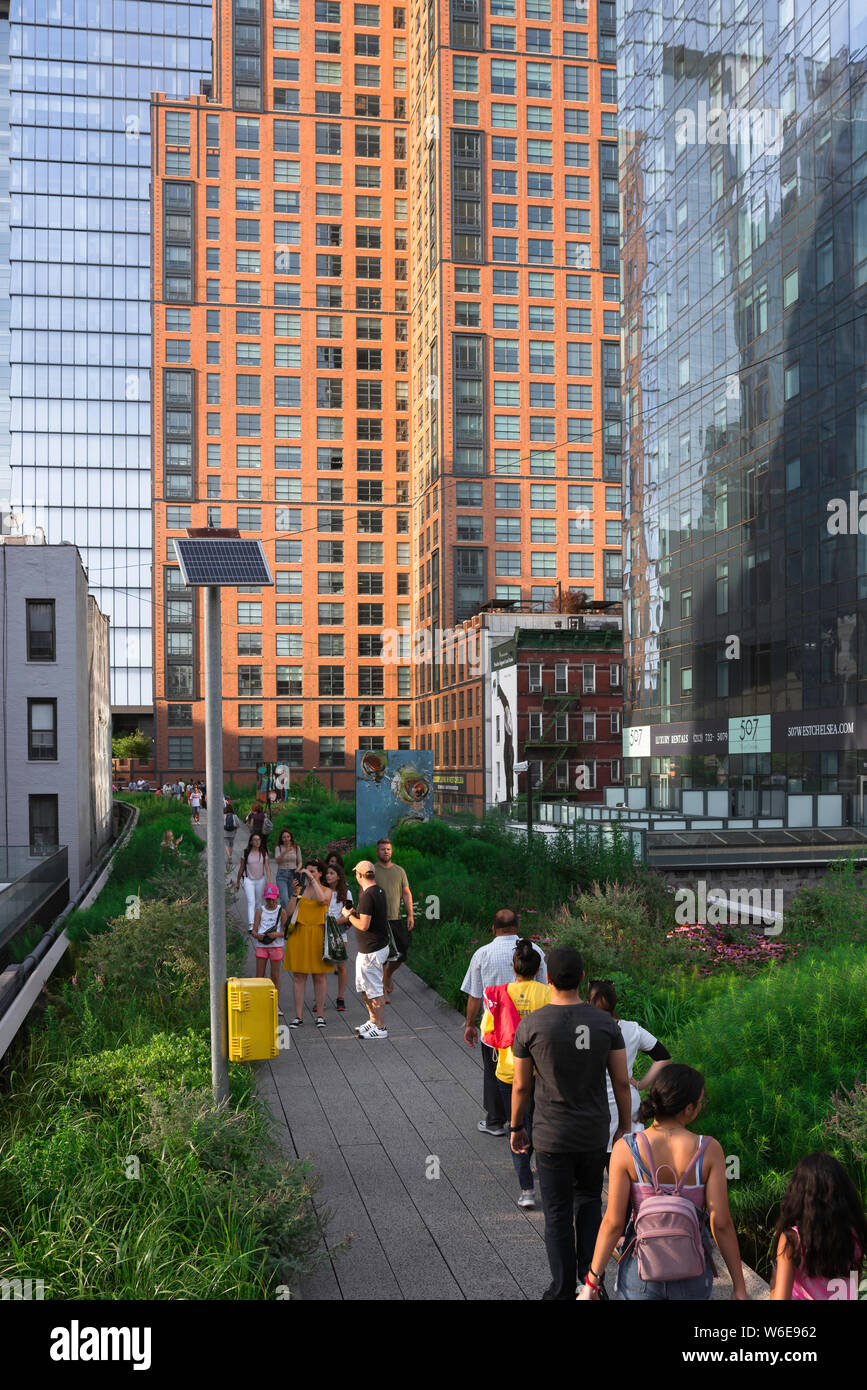 Manhattan High Line, view of people on a summer evening walking the High Line park in the Chelsea neighborhood of Manhattan, New York City. Stock Photo