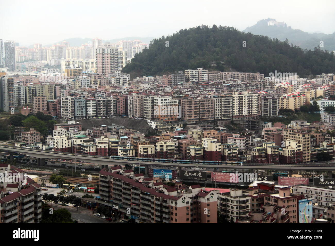 --FILE--Aerial view of old houses and high-rise residential buildings ...