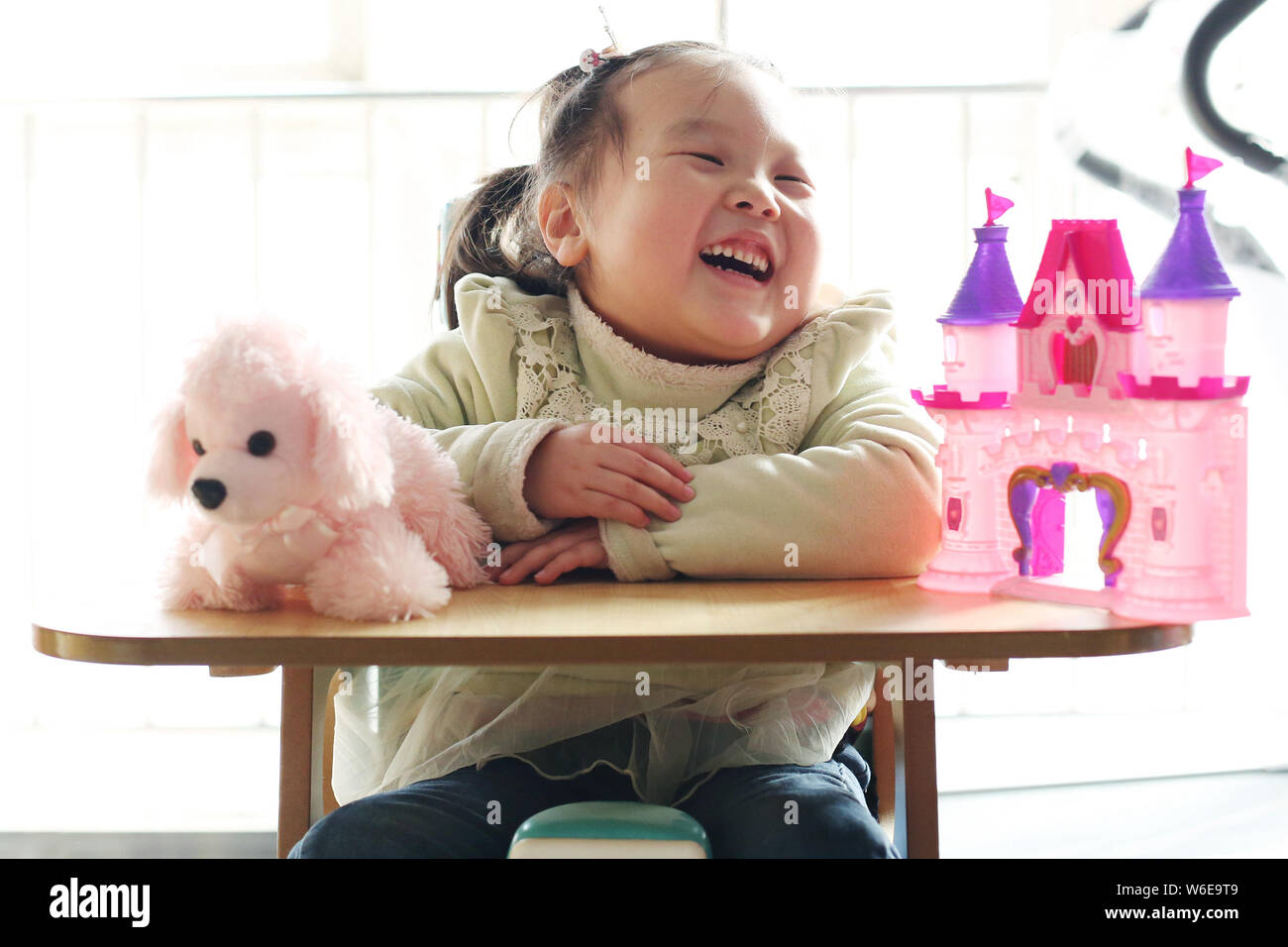 5-year-old 'sponge girl' Lele diagnosed with Spinal muscular atrophy (SMA), a rare neuromuscular disorder and often leading to early death, plays with Stock Photo