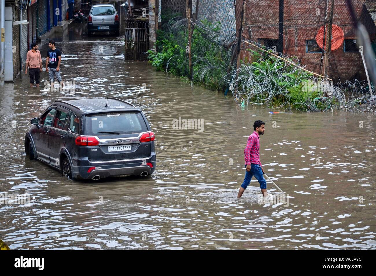 Srinagar, India. 01st Aug, 2019. A man wades after the heavy rains in Srinagar.Rains caused water-logging in many areas of Srinagar exposing the poor drainage system of the city. The weather department has predicted heavy rainfall for next few days all over the region. Credit: SOPA Images Limited/Alamy Live News Stock Photo