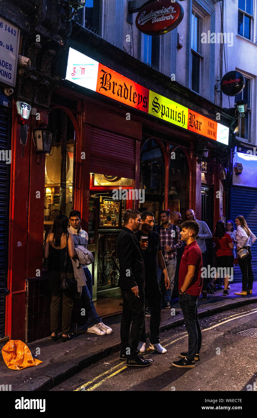 A group of patrons drinking outside Bradley's Spanish Bar, 42-44 Hanway St, Fitzrovia, London W1T 1UT, England, UK. Stock Photo