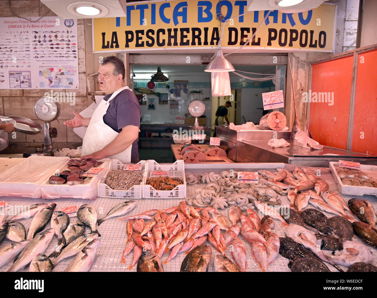 Old Ortigia market, Siracusa Sicily fishmonger at his stall Stock Photo