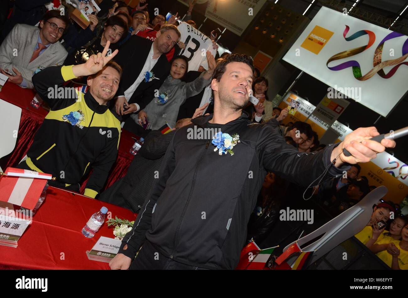 Retired German football player Michael Ballack, front, takes selfies with fans during a press conference for Beamy Booth of Domotex Shanghai exhibitio Stock Photo