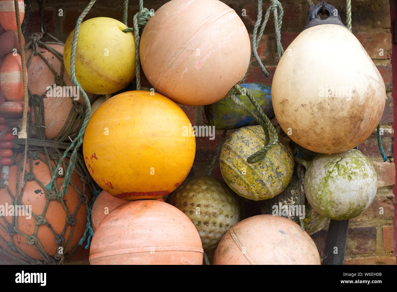 Old dirty, faded, weathered fishing buoys, floats, hanging on a