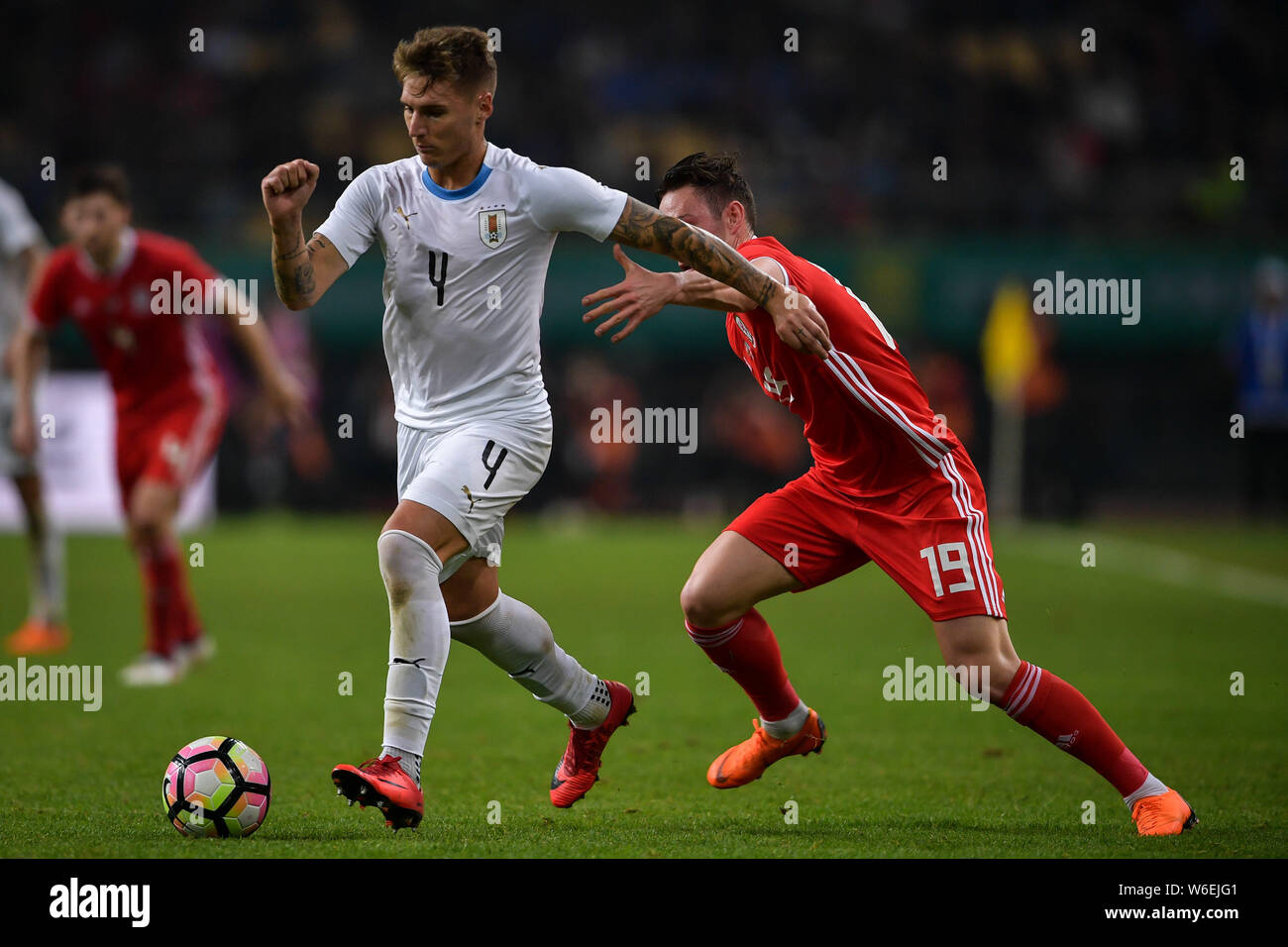 Guillermo Varela, left, of Uruguay national football team kicks the ball to make a pass against Connor Roberts of Wales national football team in thei Stock Photo