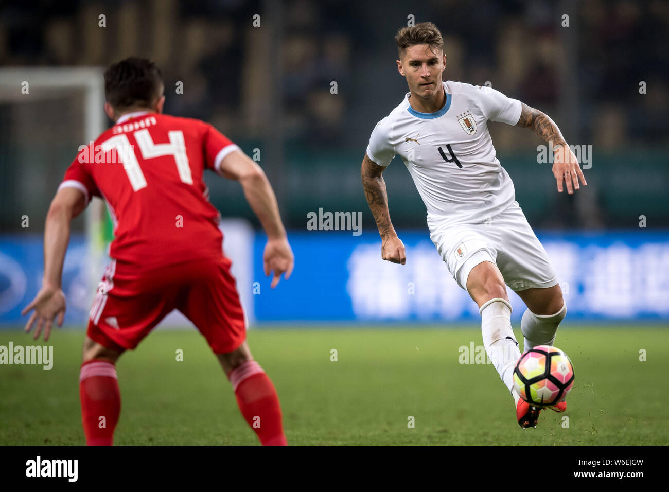 Guillermo Varela of Uruguay national football team dribbles against Wales national football team in their final match during the 2018 Gree China Cup I Stock Photo