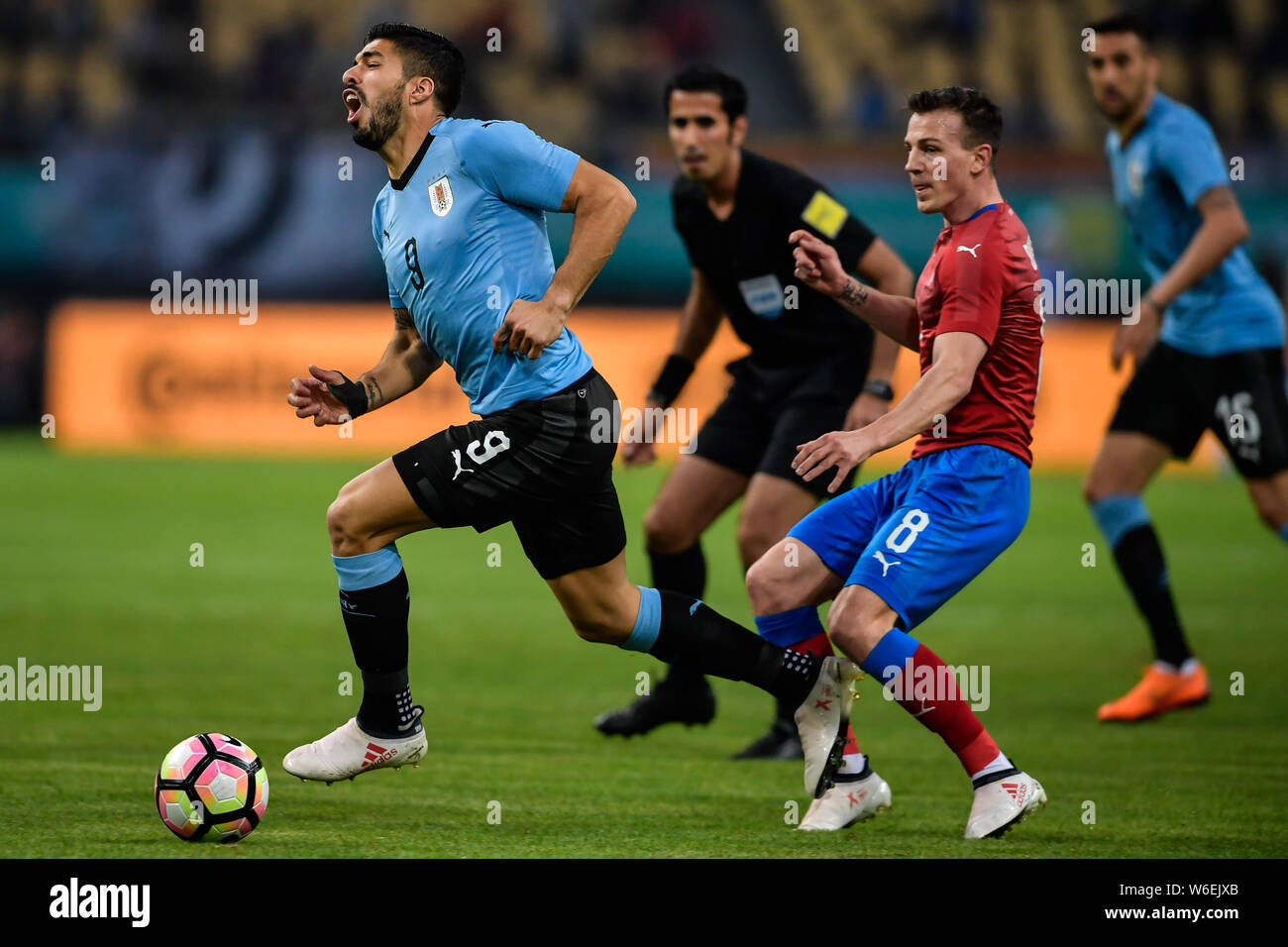 Luis Suarez, left, of Uruguay national football team kicks the ball to make a pass against Vladimir Darida of Czech Republic national football team in Stock Photo