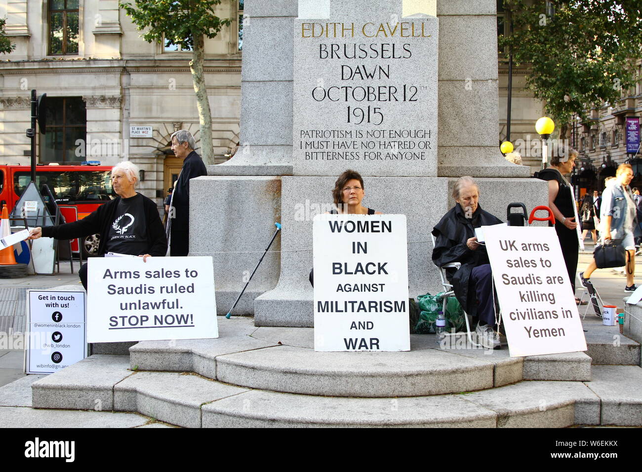 WOMEN IN BLACK AGAINST MILITARISM AND WAR PROTEST AT THE EDITH CAVELL STATUE OF HUMANITY IN SAINT MARTINS PLACE, LONDON, UK ON 31ST JULY 2019. UK ARMS SALES ARE KILLING CIVILIANS IN YEMAN. ARMS SALES TO SAUDI ARABIA RULED UNLAWFUL BY THE COURT OF APPEAL. ENGLISH COURTS. BRITISH COURTS. HUMANITARIAN PROTEST. Stock Photo