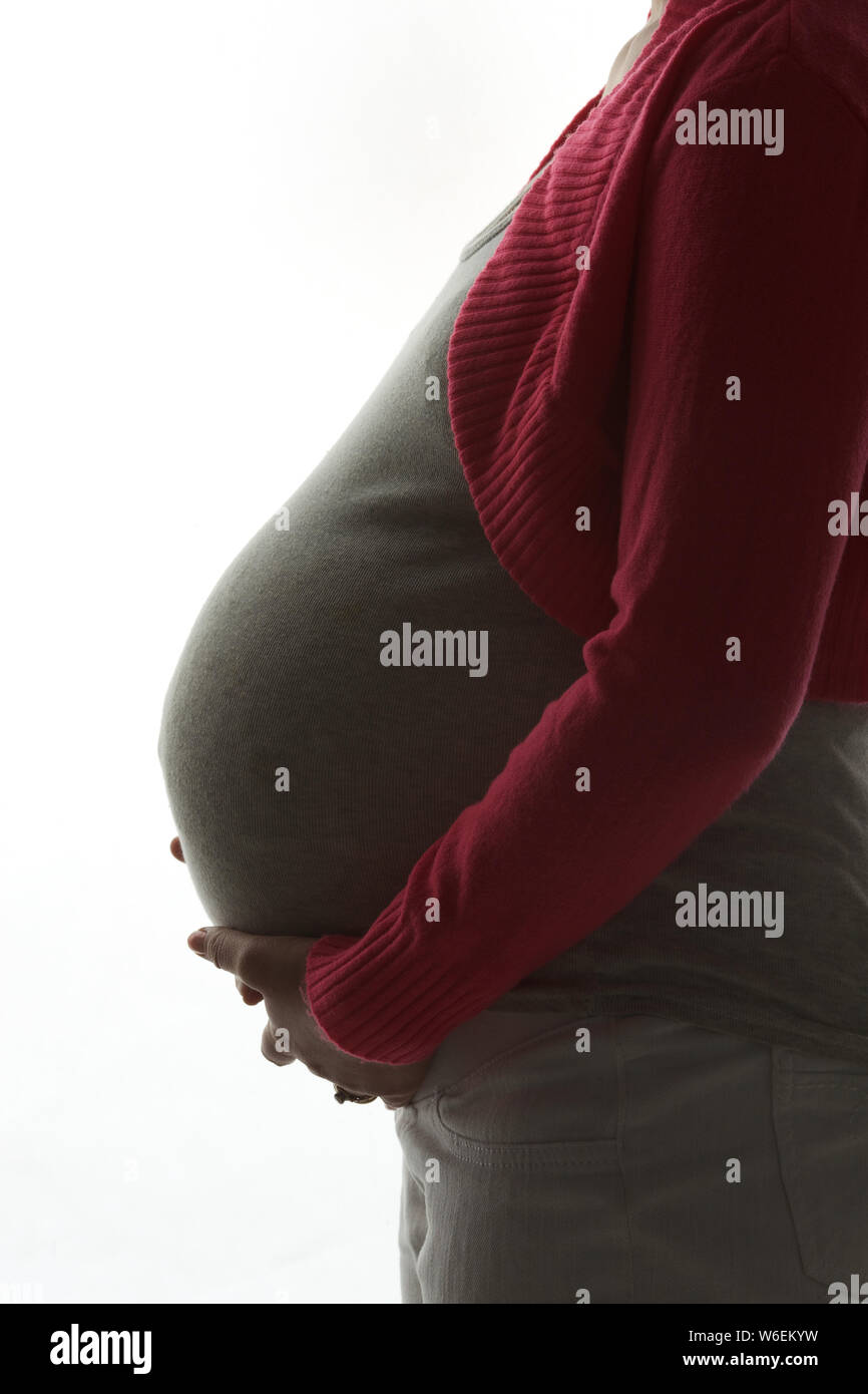 Mid section view of a pregnant woman Stock Photo - Alamy