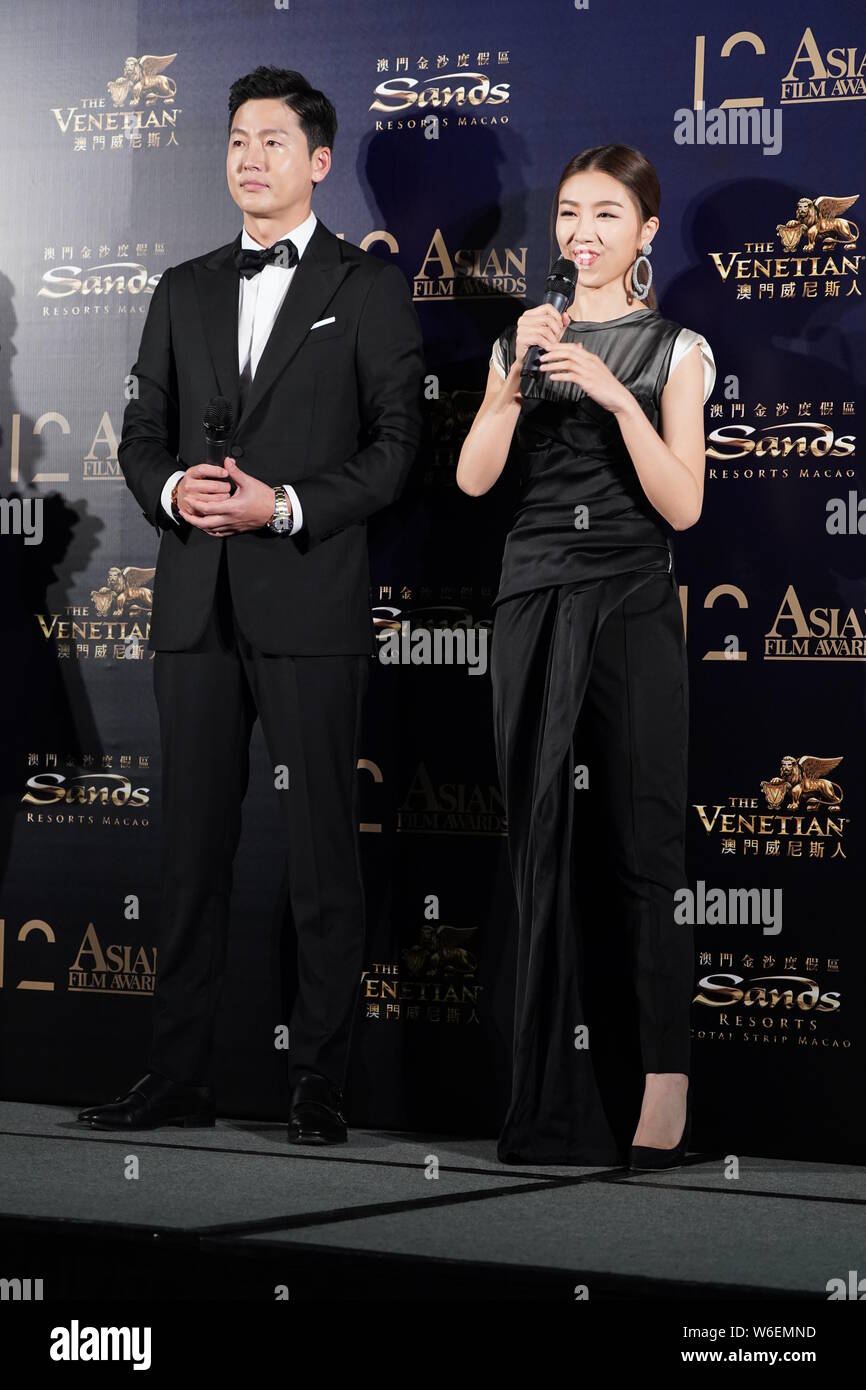South Korean actor Lee Jung-jin, left, poses as he arrives on the red carpet for the 12th Asian Film Awards in Macau, China, 17 March 2018. Stock Photo