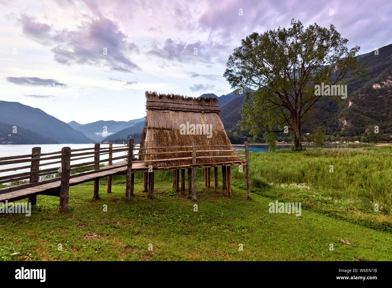 Stilt house of the Bronze Age (reconstruction) at Lake Ledro. Ledro valley, Trento province, Trentino Alto-Adige, Italy, Europe. Stock Photo