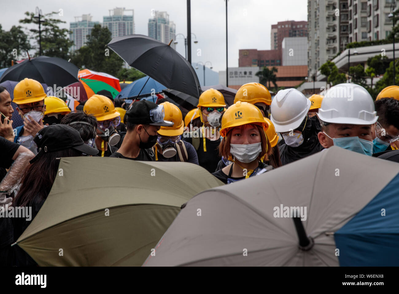 Protesters gather with umbrellas and hard hats during anti-extradition bill demonstrations in Sha Tin, Hong Kong on the 14th of July 2019. Pro-democracy protesters continue with demonstrations as they call for the complete withdrawal of a controversial extradition bill and the resignation of Hong Kong Chief Executive Carrie Lam. Stock Photo