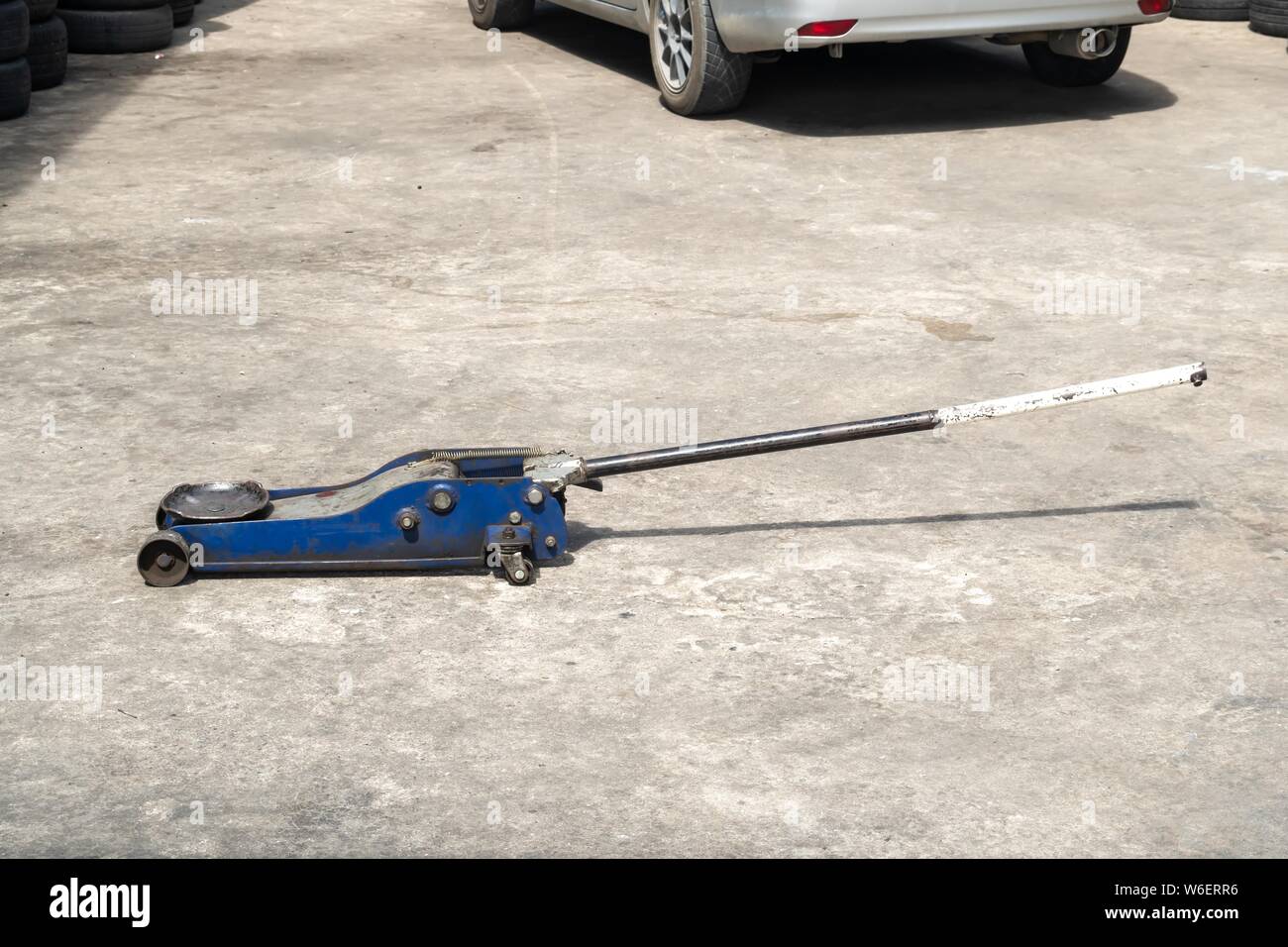 Used hydraulic vehicle jack or vehicle lifting for inspection of vehicle underbody, brake repairs. Stock Photo