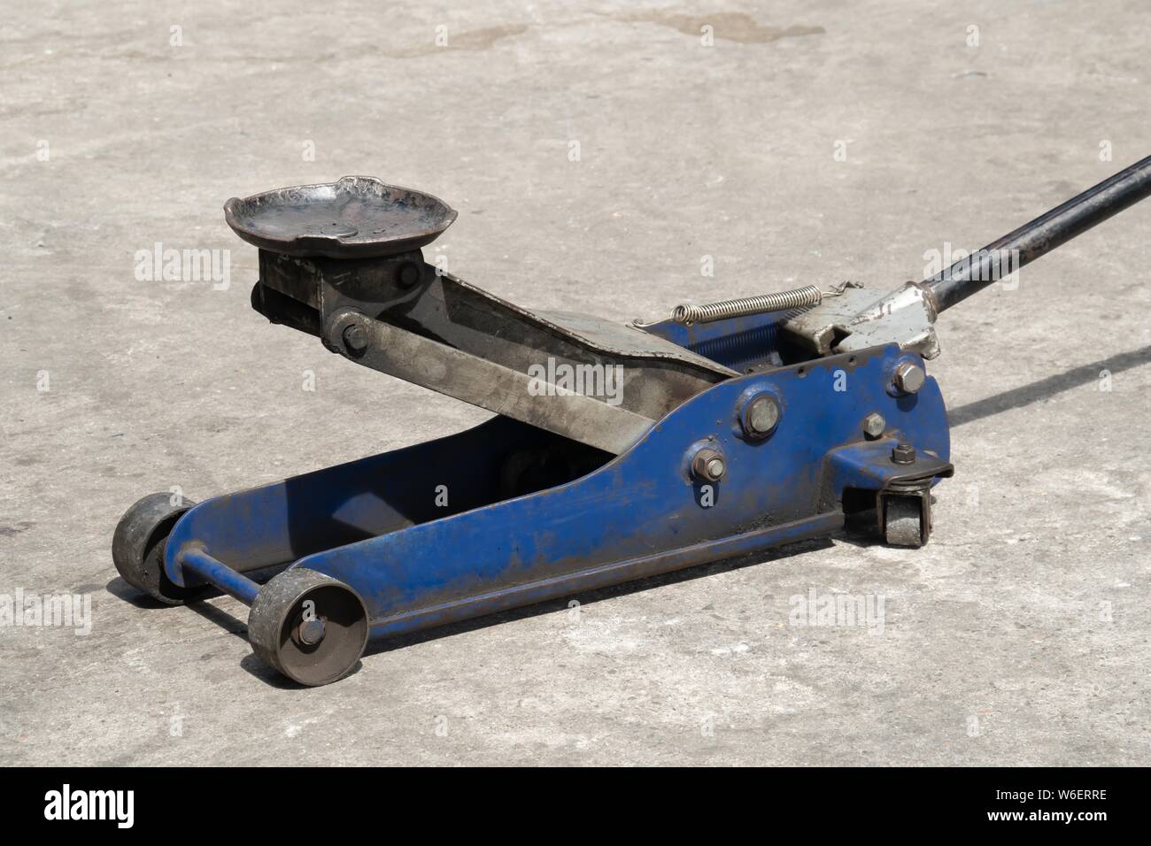 Used hydraulic vehicle jack or vehicle lifting for inspection of vehicle underbody, brake repairs. Stock Photo