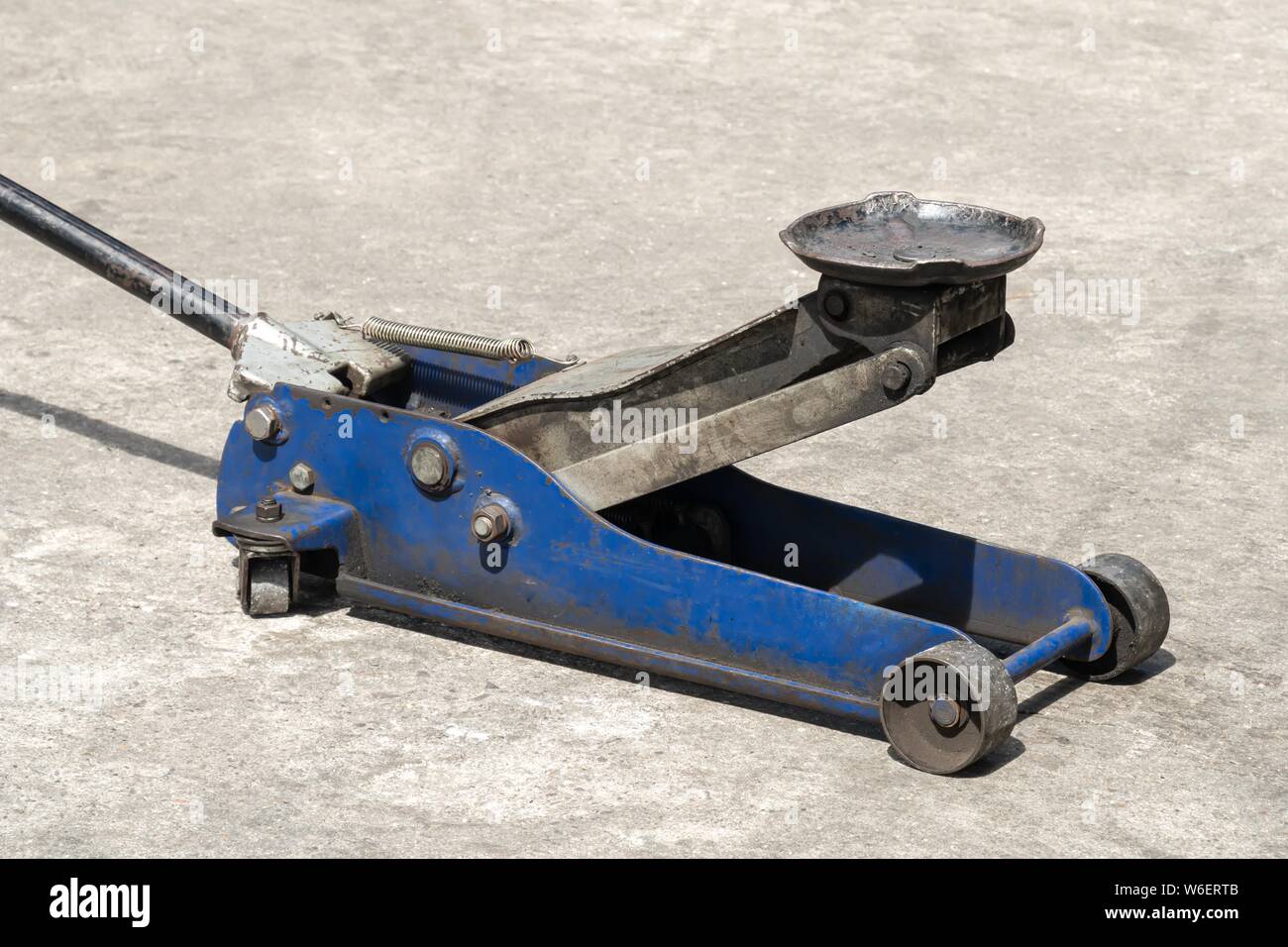 Used hydraulic vehicle jack or vehicle lifting for inspection of vehicle underbody, brake repairs. Stock Photo