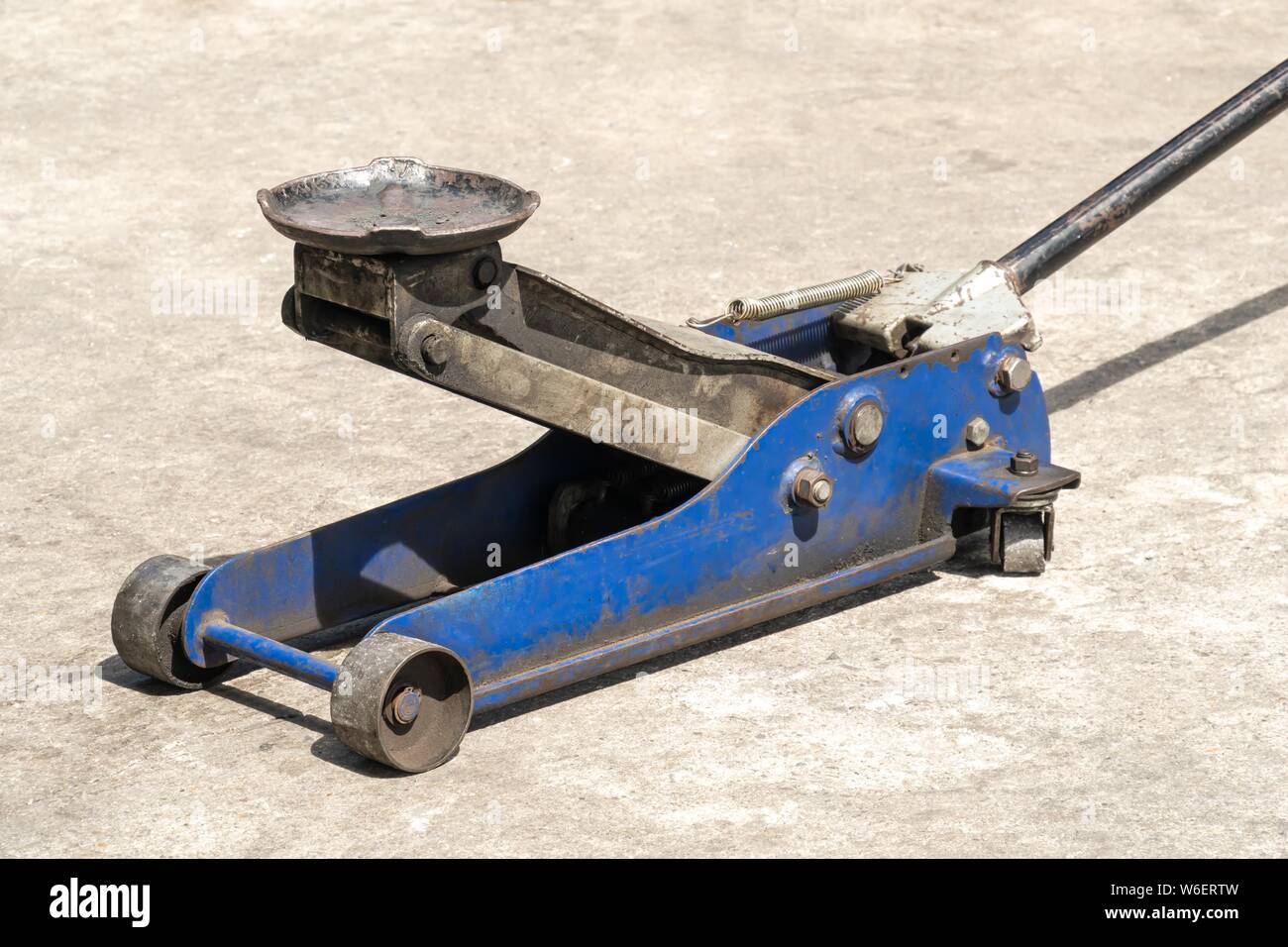Used hydraulic vehicle jack or vehicle lifting for inspection of vehicle underbody, brake repairs. Stock Photo