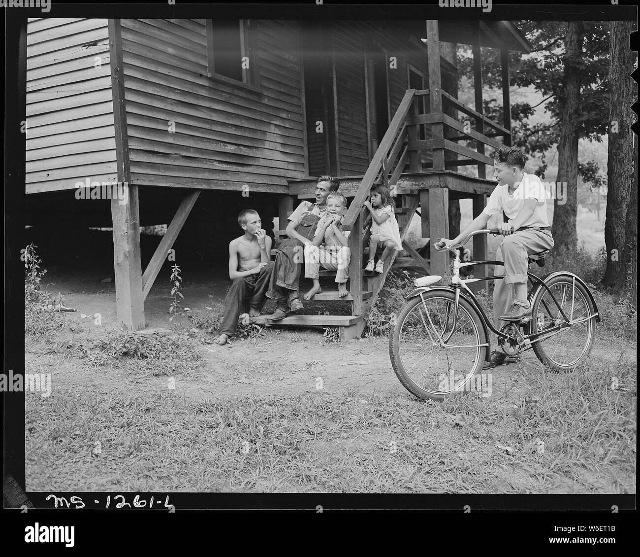 A miner and children on steps of a typical house. Kingston Pocahontas