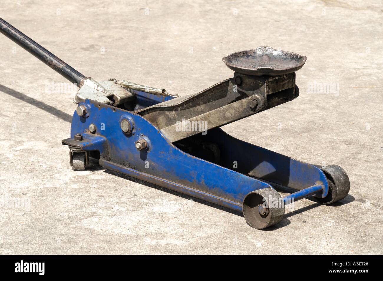 Used hydraulic vehicle jack or vehicle lifting for inspection of vehicle underbody, brake repairs. Stock Photo