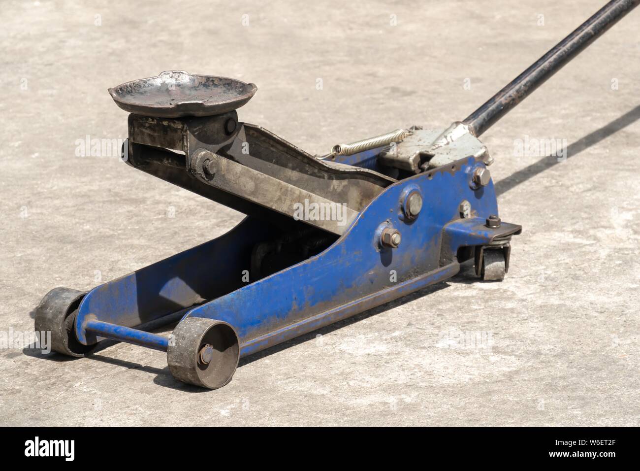 Used hydraulic vehicle jack or vehicle lifting for inspection of vehicle underbody, brake repairs. Stock Photo