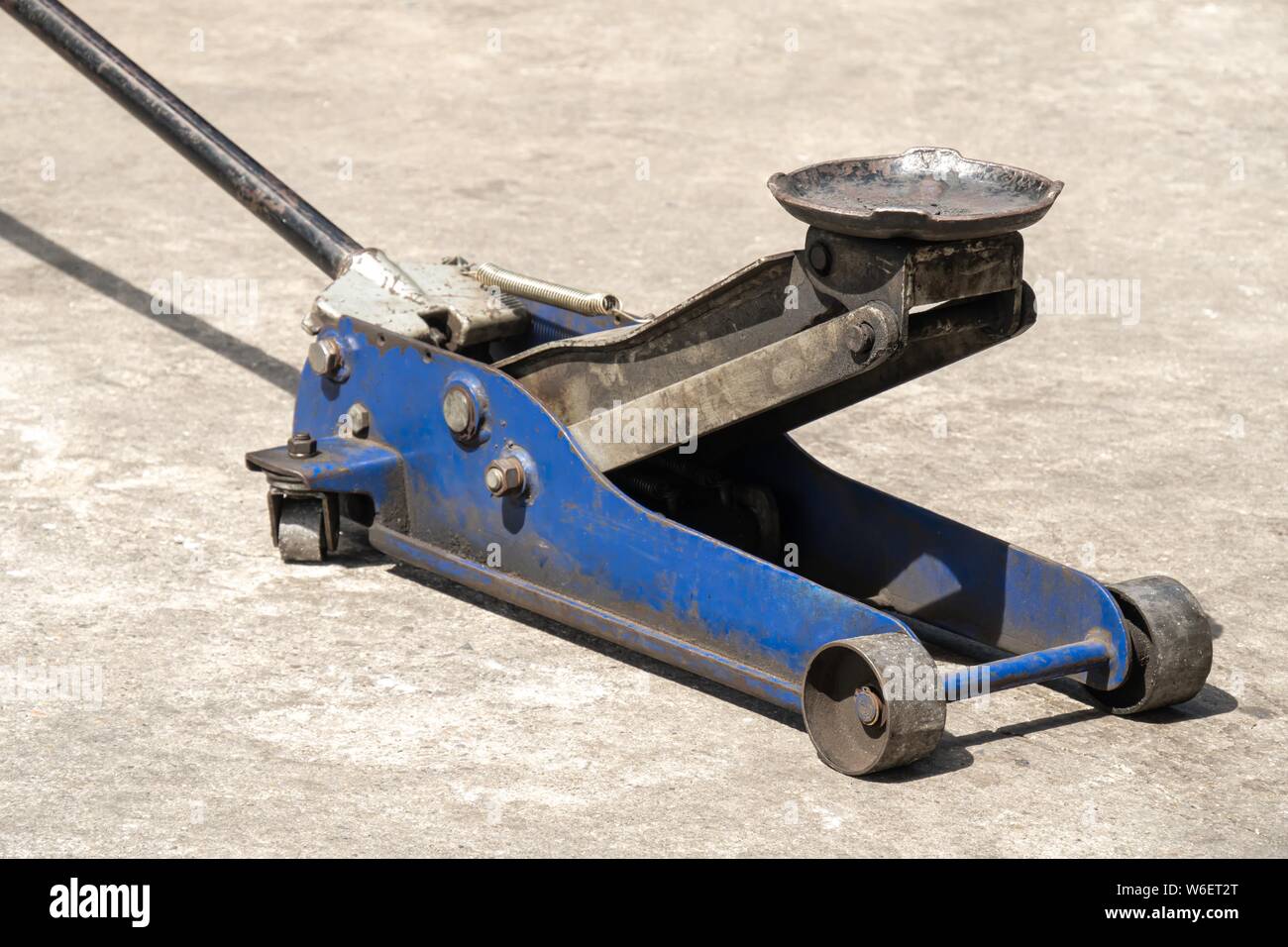 Used hydraulic vehicle jack or vehicle lifting for inspection of vehicle underbody, brake repairs. Stock Photo