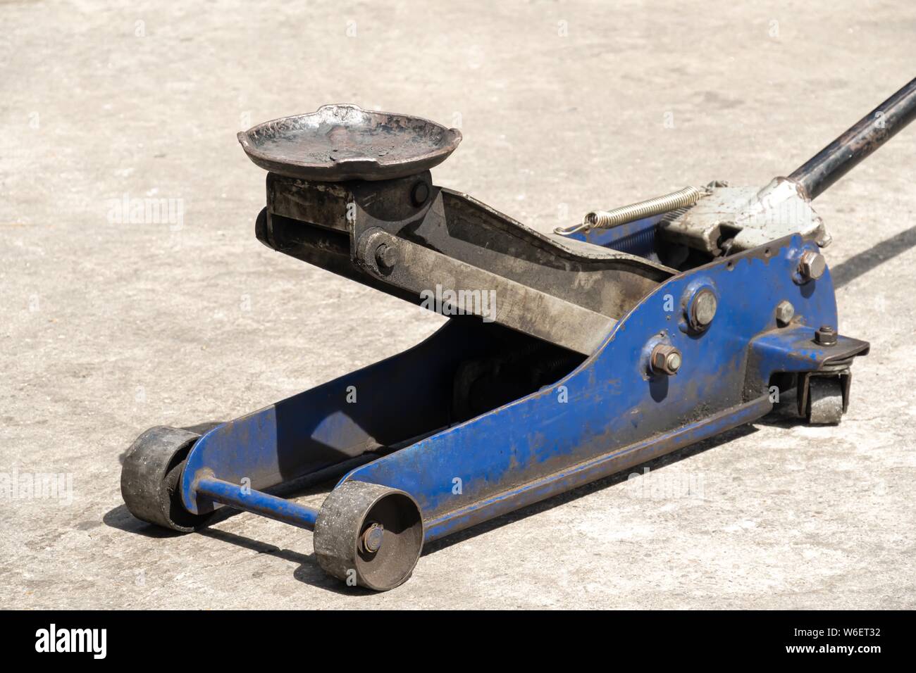 Used hydraulic vehicle jack or vehicle lifting for inspection of vehicle underbody, brake repairs. Stock Photo