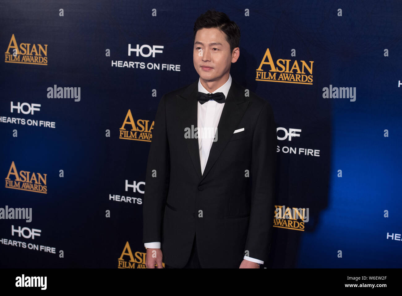 South Korean actor Lee Jung-jin poses as he arrives on the red carpet for the 12th Asian Film Awards in Macau, China, 17 March 2018. Stock Photo