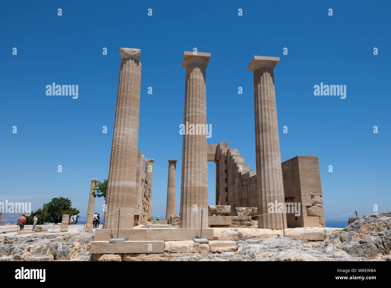 Greece, Rhodes. Historic Lindos, medieval Acropolis of Lindos. 4th century B.C. Doric style columns of the Temple of Athena Lindia. Stock Photo
