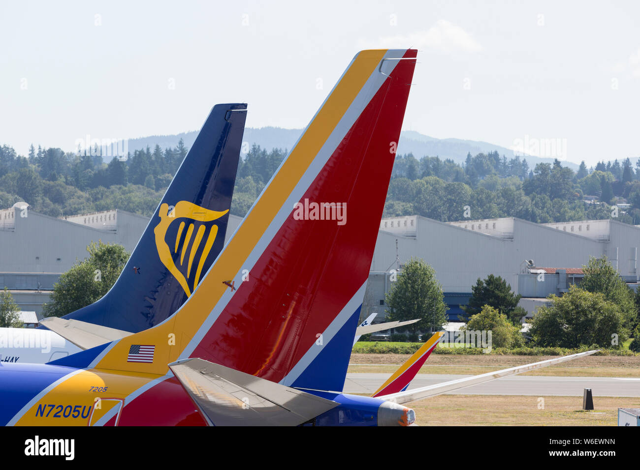 Two grounded 737 MAX airplanes for Southwest Airlines and Ryanair parked at Renton Field in Renton, Washington on July 31, 2019. In the distance is the Renton Assembly Plant building where the P-8 Poseidon is produced. Stock Photo