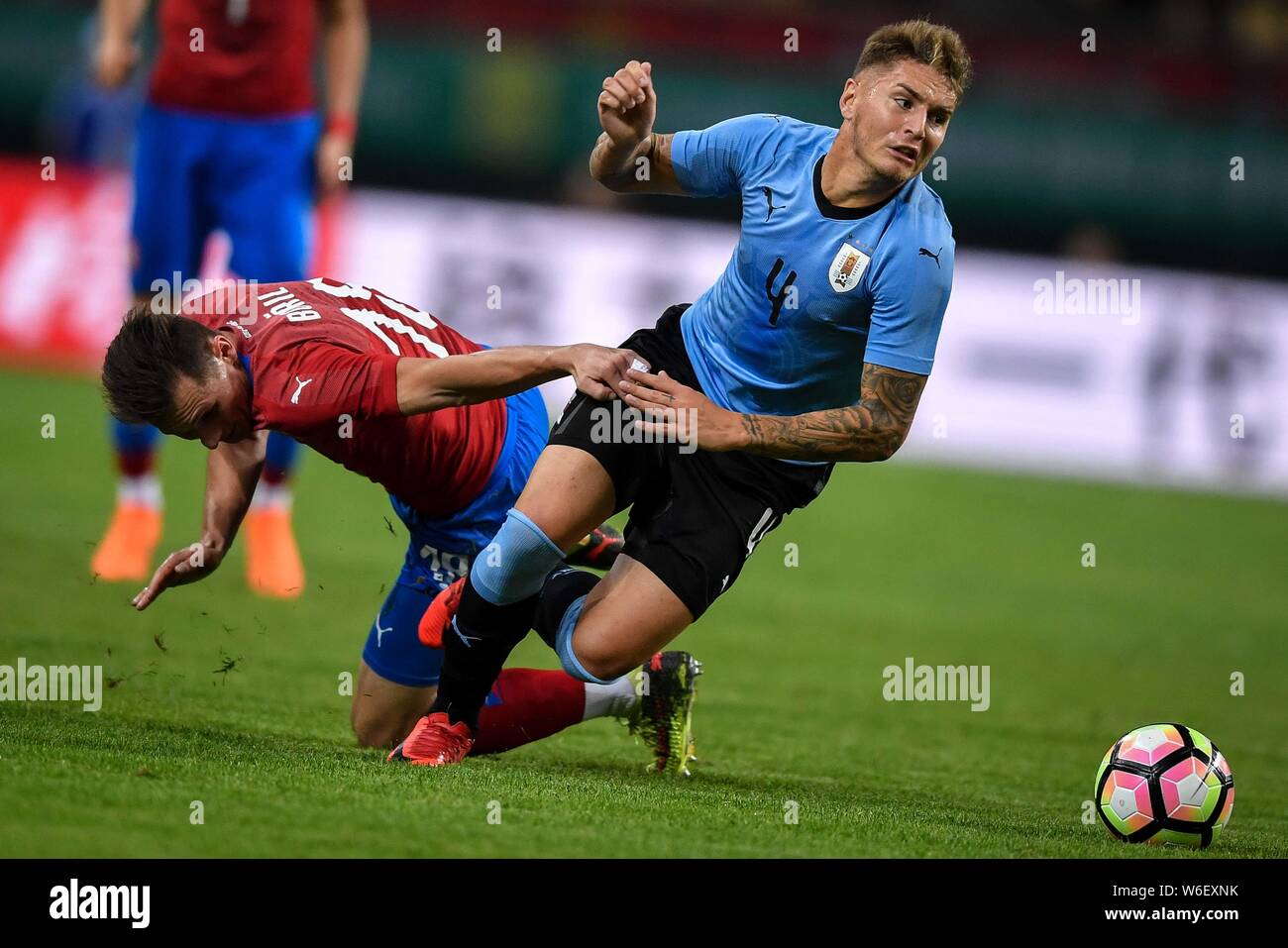 A player of Czech Republic national football team challenges Guillermo Varela, right, of Uruguay national football team in their semi-final match duri Stock Photo
