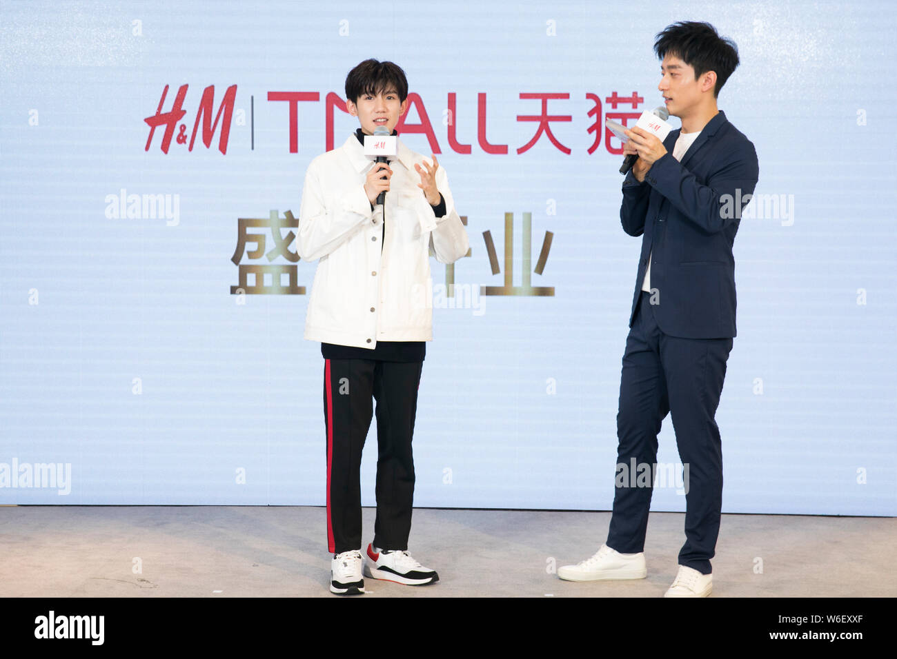 Roy Wang or Wang Yuan, left, of Chinese boy group TFBoys attends the launch  ceremony for fashion retailer H&M on the online shopping site Tmall.com of  Stock Photo - Alamy