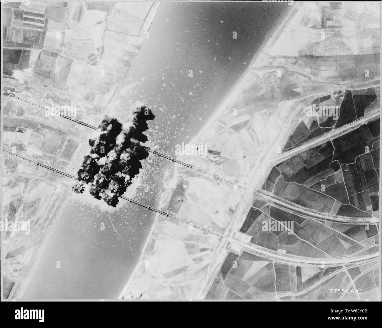 AIR FORCE B-29s STRIKE RAILROAD BRIDGES; Scope and content:  AIR FORCE B-29s STRIKE RAILROAD BRIDGES. Ten tons of bombs from Air Force B-29 Superforts of the FEAF Bomber Command sever these two important railroad bridges near Pakchon, 40 miles north of Pyongyang, in North Korea in an attack made on July 27, 1950. As Captain Meterio Montez of Gardner, Colorado, lead bombardier, released his bombs, the Superforts in the formation did likewise. Montez was in the B-29 piloted by Captain Leslie Westberg, Spokane, Washington. Military supply traffic from North Korea formerly routed over these rail l Stock Photo