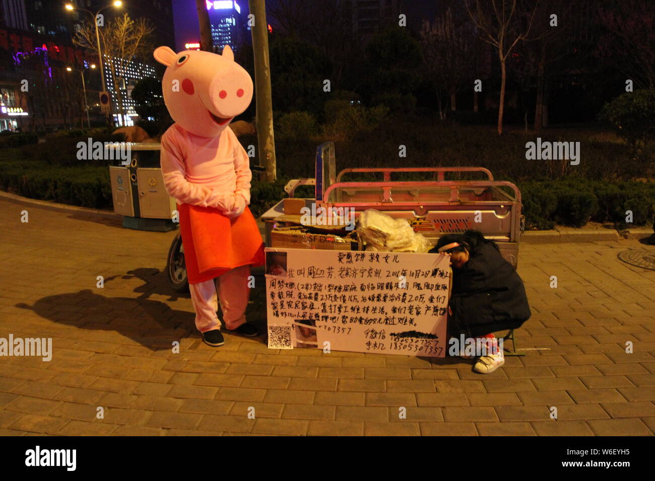 Chinese father Mr. Zhou, who is dressed up as Peppa Pig to raise money for the treatment of his three-year-old daughter with type 1 diabetes mellitus, Stock Photo