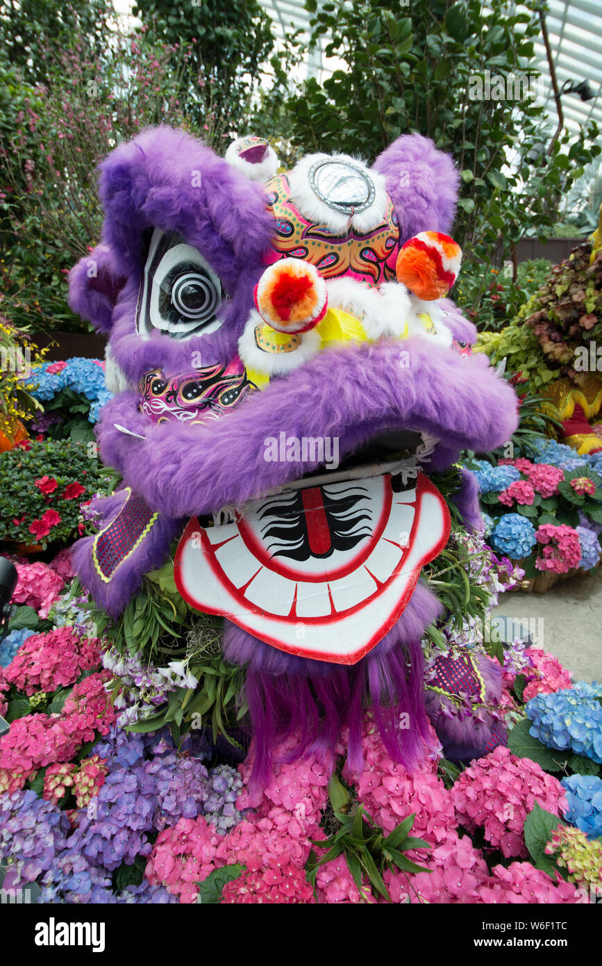 Chinese lion surrounded by hydrangeas Stock Photo