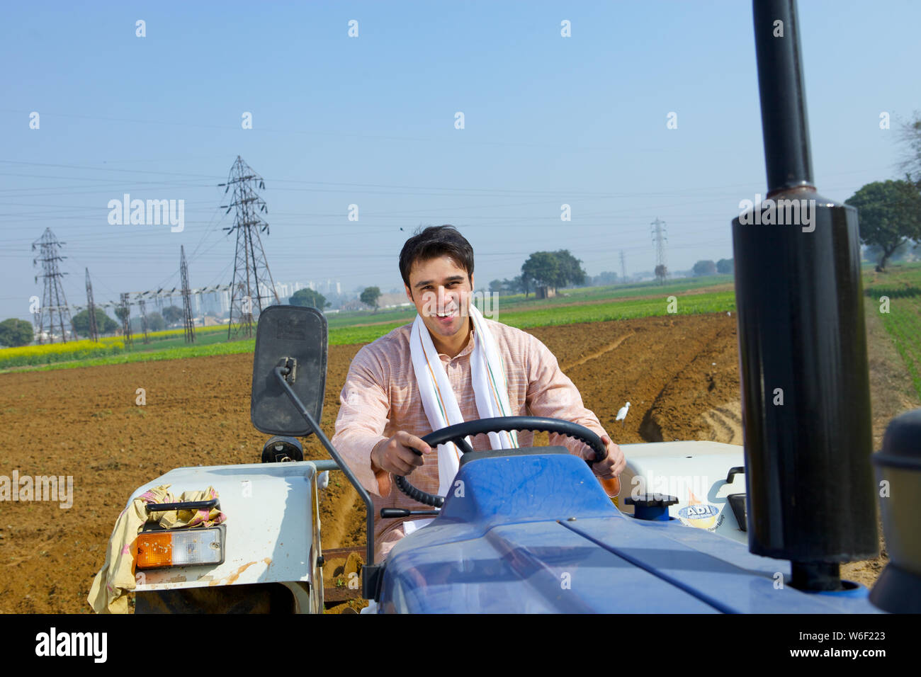 Indian farmer ploughing field tractor hi-res stock photography and ...