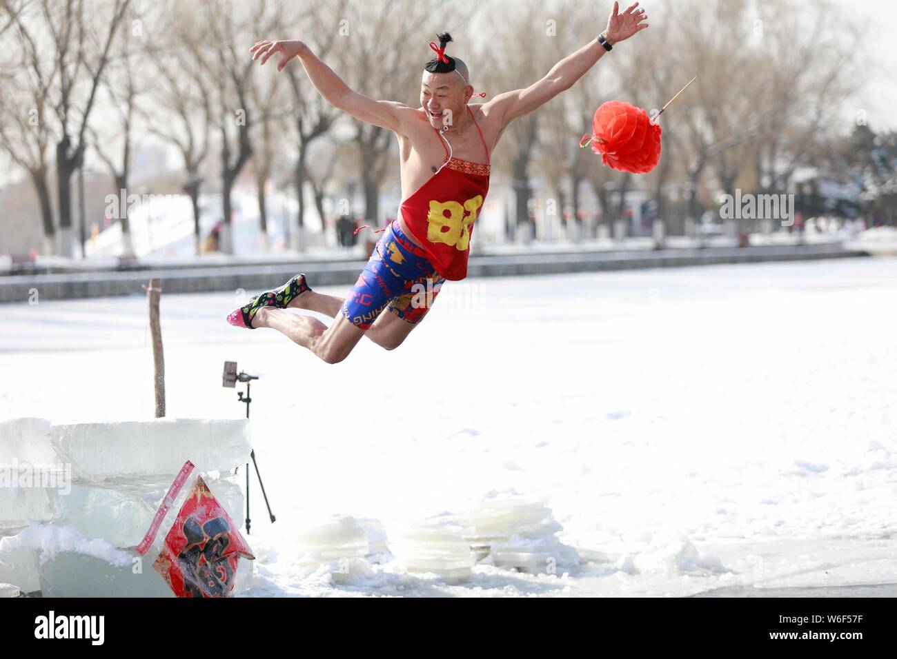 A Chinese winter swimming enthusiast performs funny diving in ...