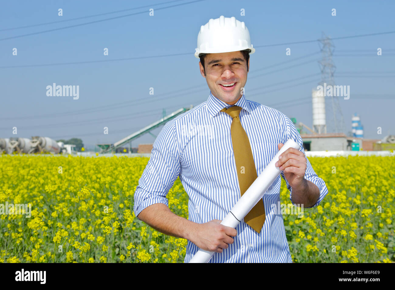 Architect holding blueprint at construction site Stock Photo - Alamy
