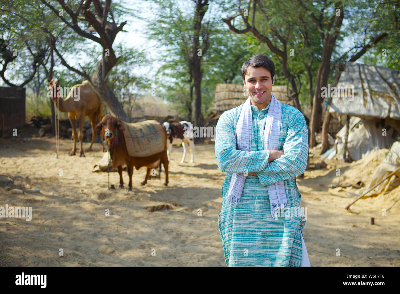 Farmer standing with his arms crossed Stock Photo - Alamy