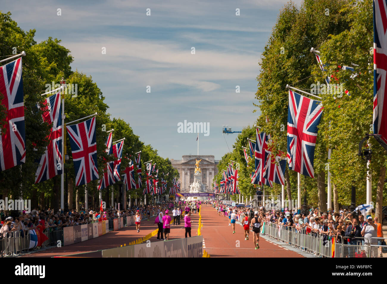 London, United Kingdom - August 13, 2017: The Mall decorated with Union Jack flags and Buckingham Palace at 50 km Race Walkers competing in the 2017 I Stock Photo