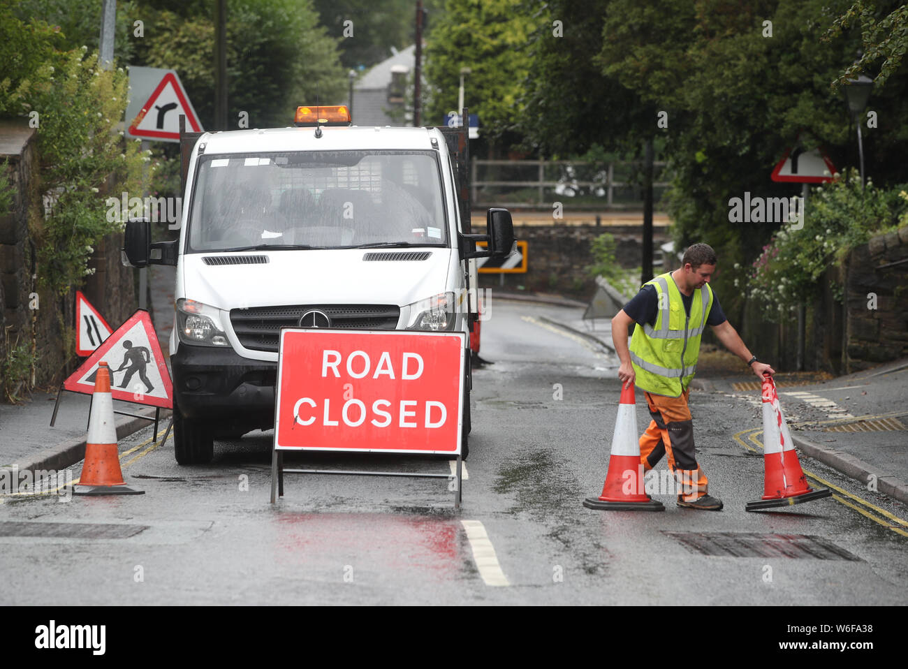A roadblock is put in place at Whaley Lane the entrance to the village of Whaley Bridge, Cheshire, after a wall around Toddbrook Reservoir, which sits above the village, was damaged in heavy rainfall. Stock Photo
