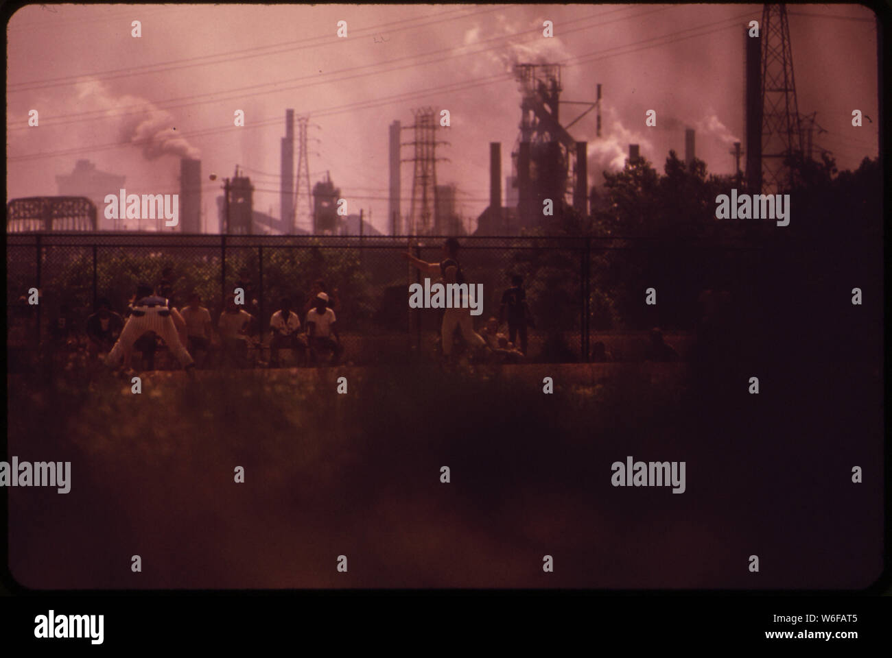 BASEBALL DIAMOND BARELY VISIBLE THROUGH SMOKE FROM REPUBLIC STEEL MILL